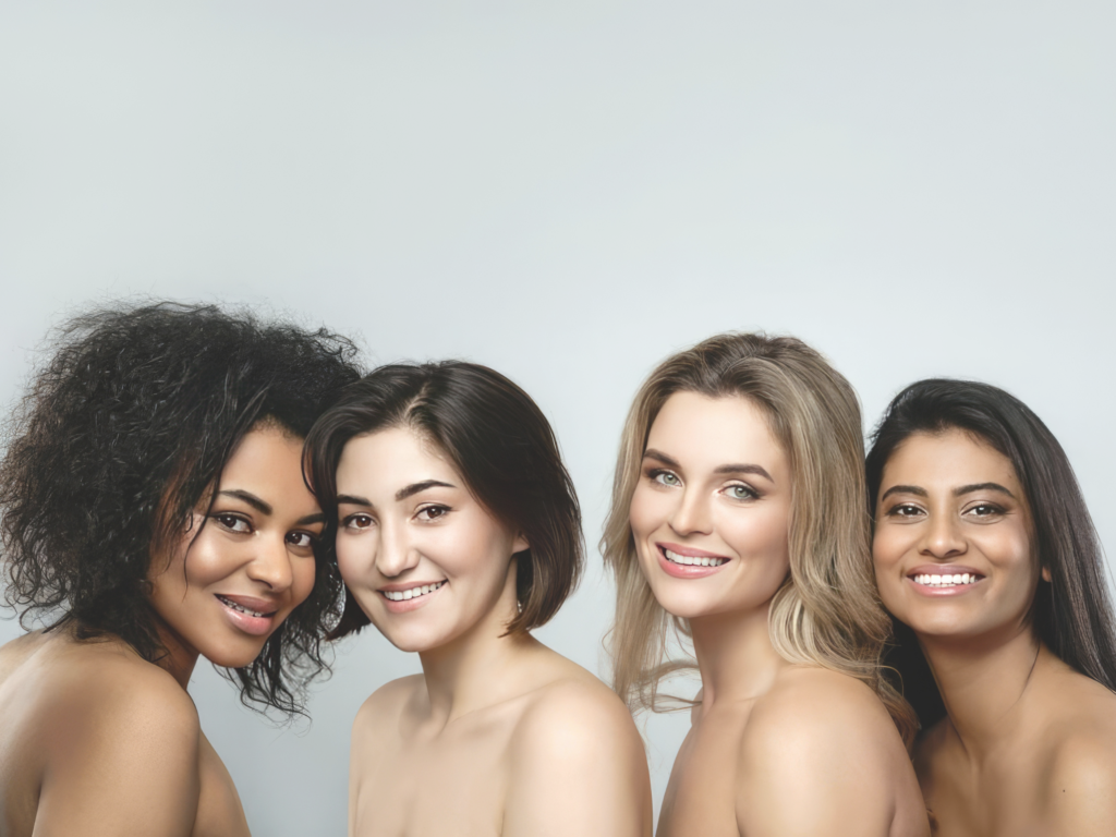 Four smiling women posing together for a beauty and skincare portrait.